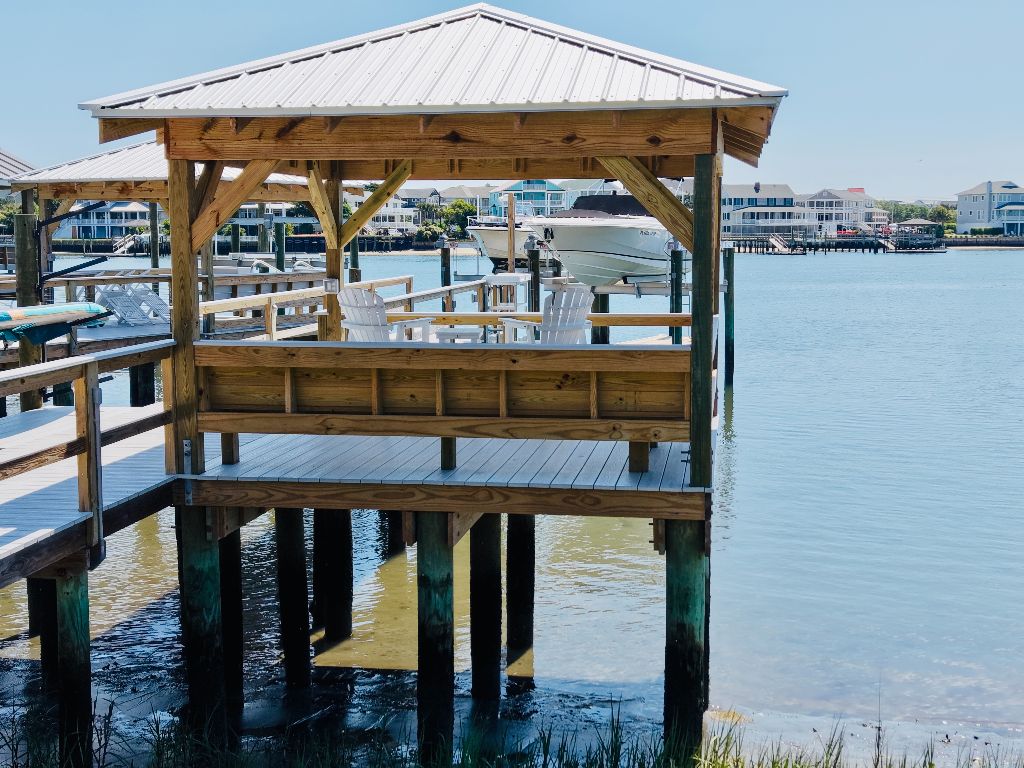 Pressure-treated gazebo with Adirondack chairs overlooking the waterway