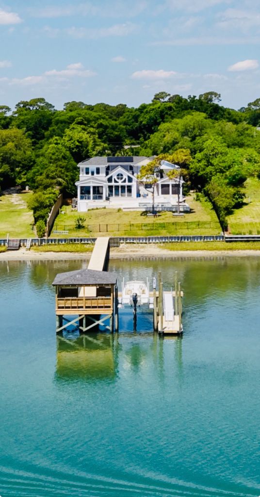 Aerial view of waterfront estate with private dock and boathouse