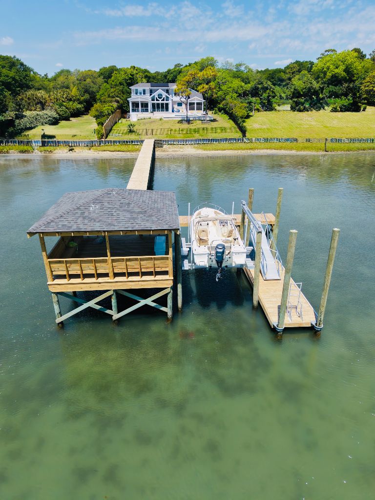 Aerial view of estate dock with boathouse and boat lift